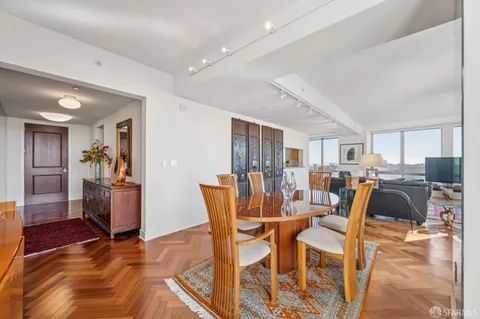 a dining room with furniture and wooden floor