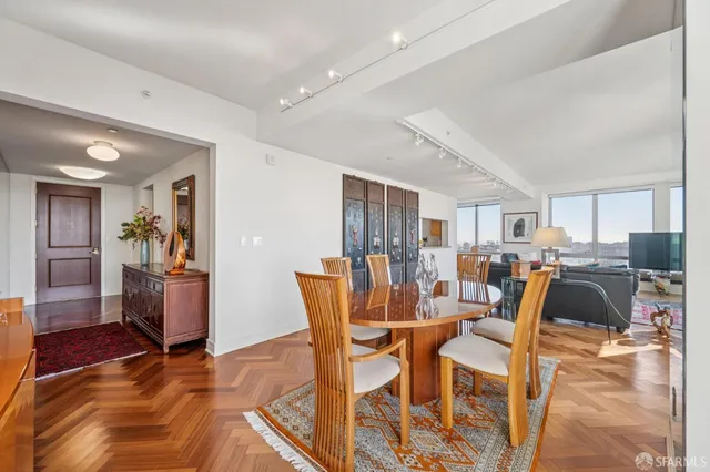 a dining room with furniture and wooden floor