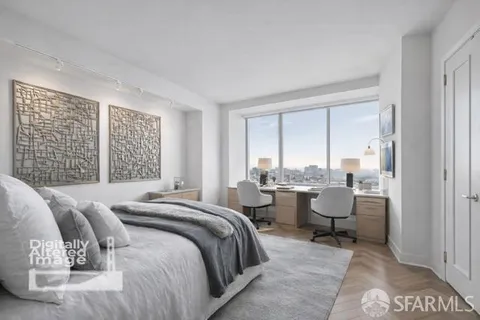 a spacious bedroom with a bed and large windows