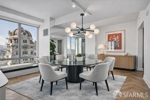 a view of a dining room with furniture and chandelier