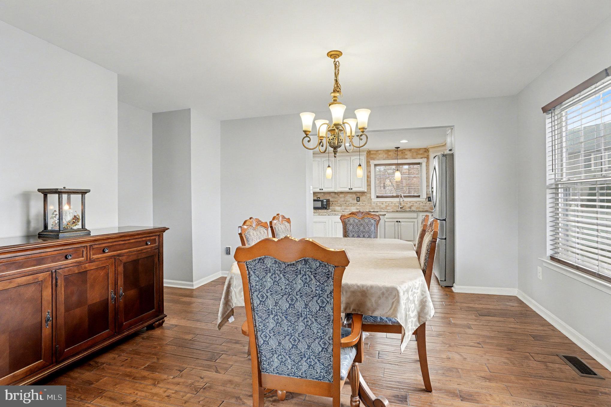 2935 Ancon Court Edgewood, MD 21040 - Photo 8 of 50 a view of a dining room with furniture a chandelier and wooden floor