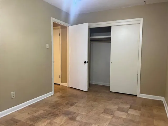 an empty room with closet area