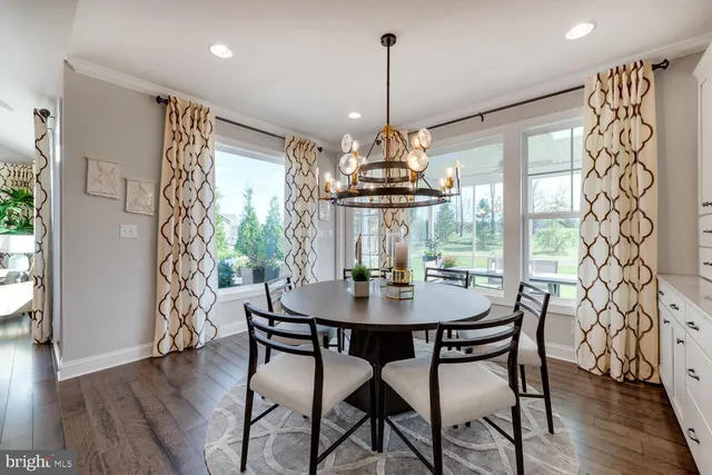 a view of a dining room with furniture wooden floor and chandelier