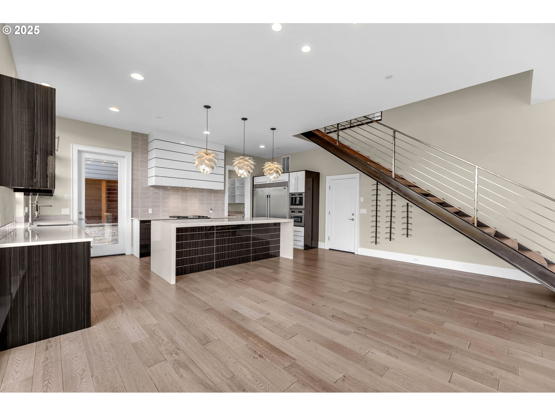 4645 North Adams Street Camas, WA 98607 - Photo 12 of 48 a kitchen with stainless steel appliances a refrigerator and wooden floor