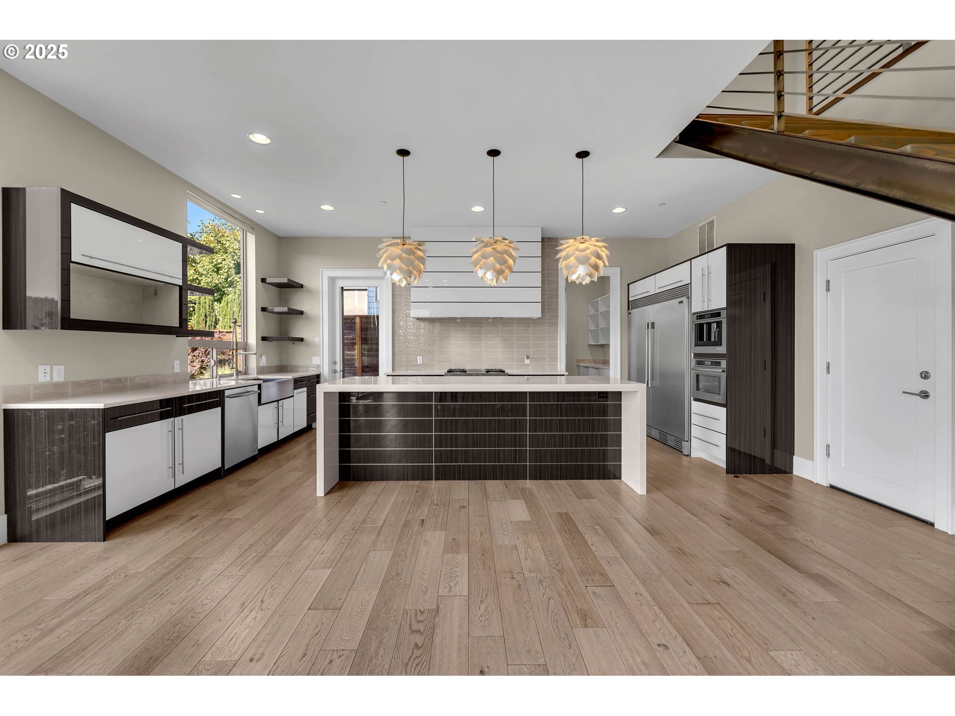 4645 North Adams Street Camas, WA 98607 - Photo 13 of 48 a kitchen with stainless steel appliances kitchen island wooden cabinets and granite counter tops