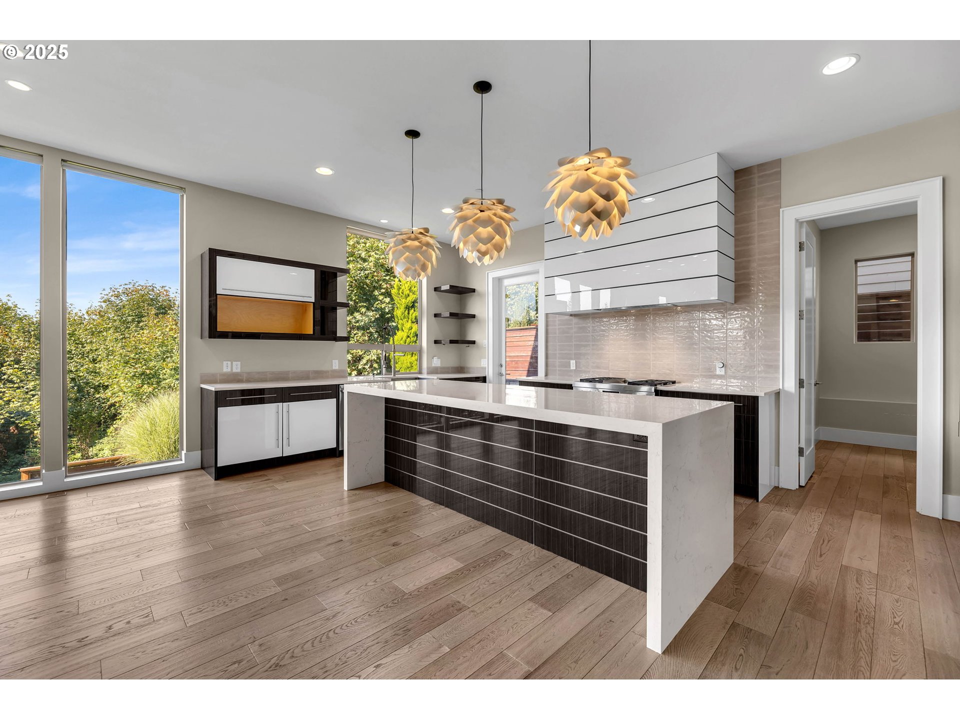 4645 North Adams Street Camas, WA 98607 - Photo 14 of 48 a kitchen with stainless steel appliances granite countertop a stove a sink and a wooden floors