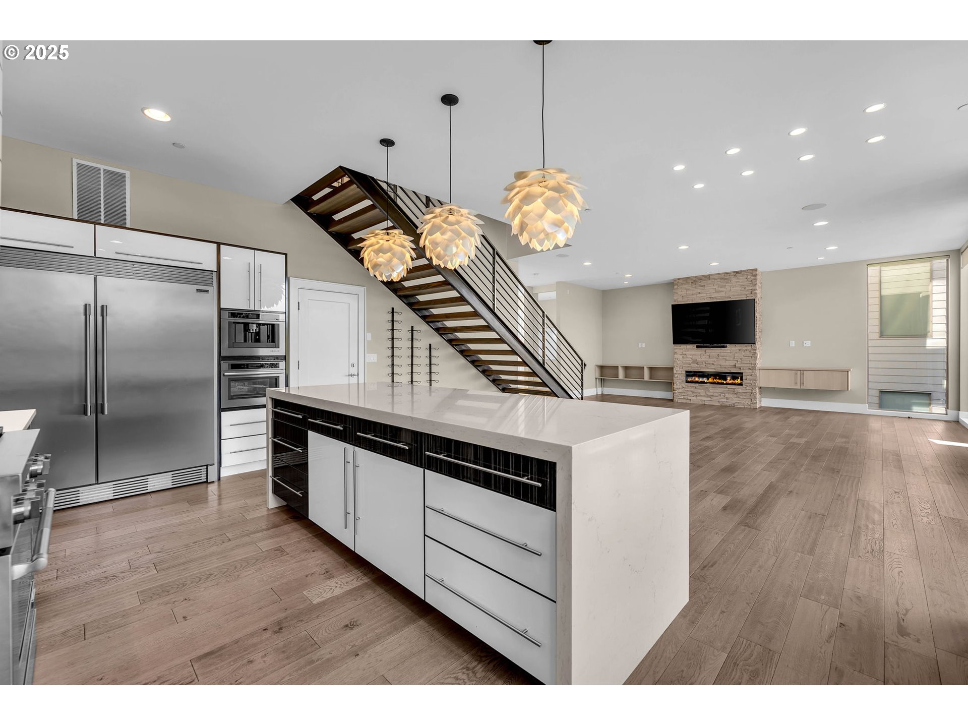 4645 North Adams Street Camas, WA 98607 - Photo 20 of 48 a kitchen with stainless steel appliances kitchen island granite countertop a stove and a wooden floor