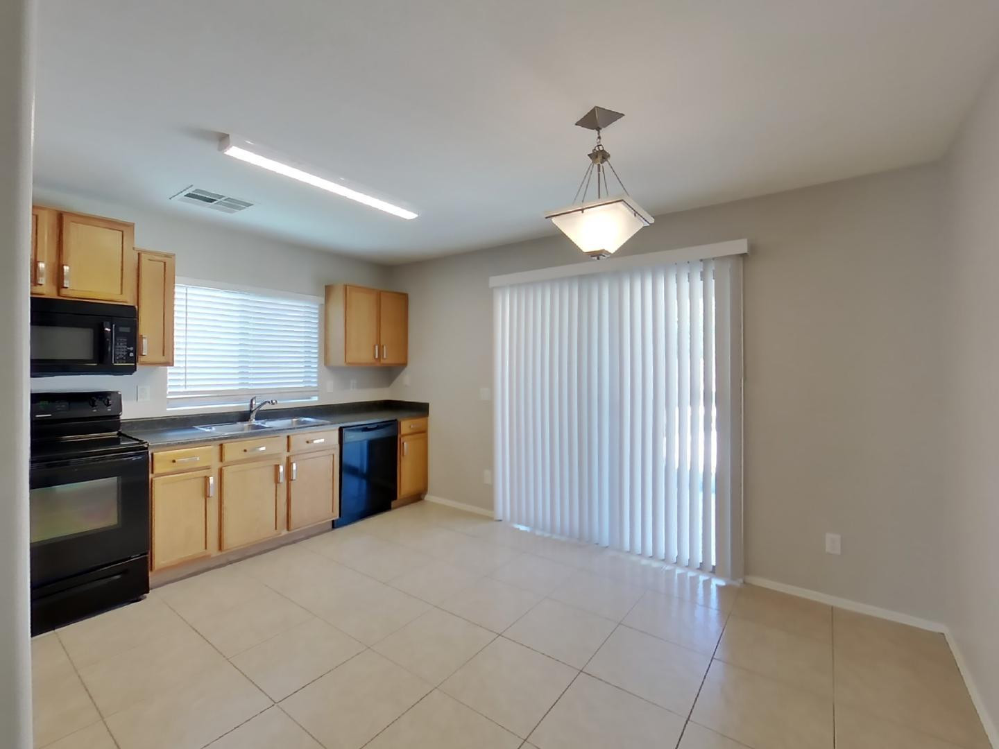 3194 West Tanner Ranch Road San Tan Valley, AZ 85144 - Photo 4 of 15 a kitchen with a refrigerator and a stove top oven