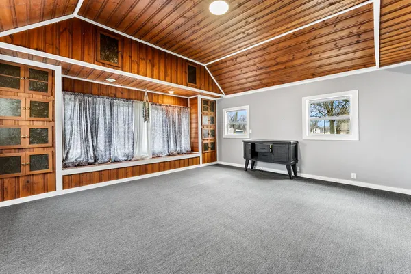 a view of an empty room with furniture and stairs