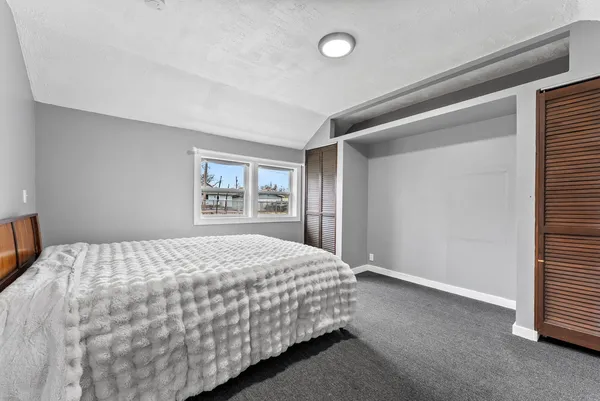 a bedroom with a bed and a window