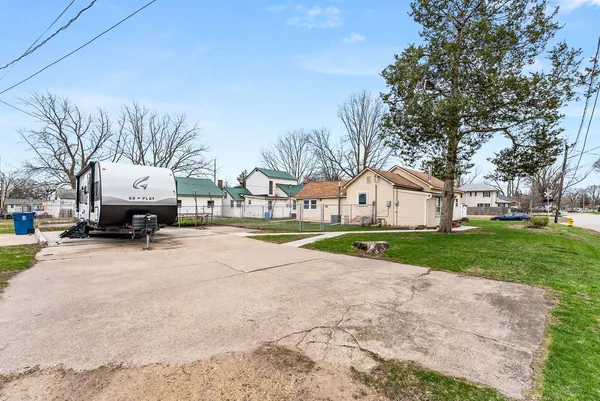 a view of house with truck parked on the side of road