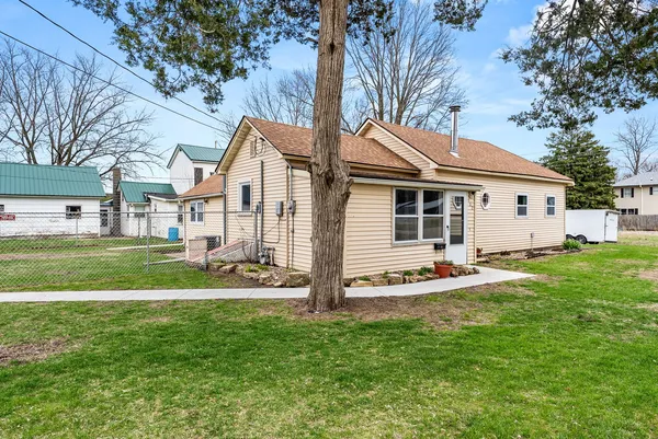 a front view of house with yard and green space