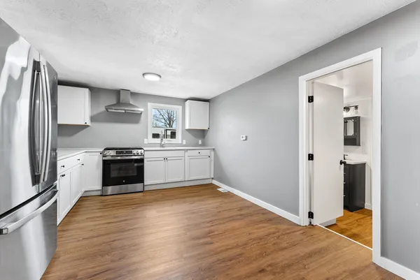 a kitchen with a refrigerator and a sink
