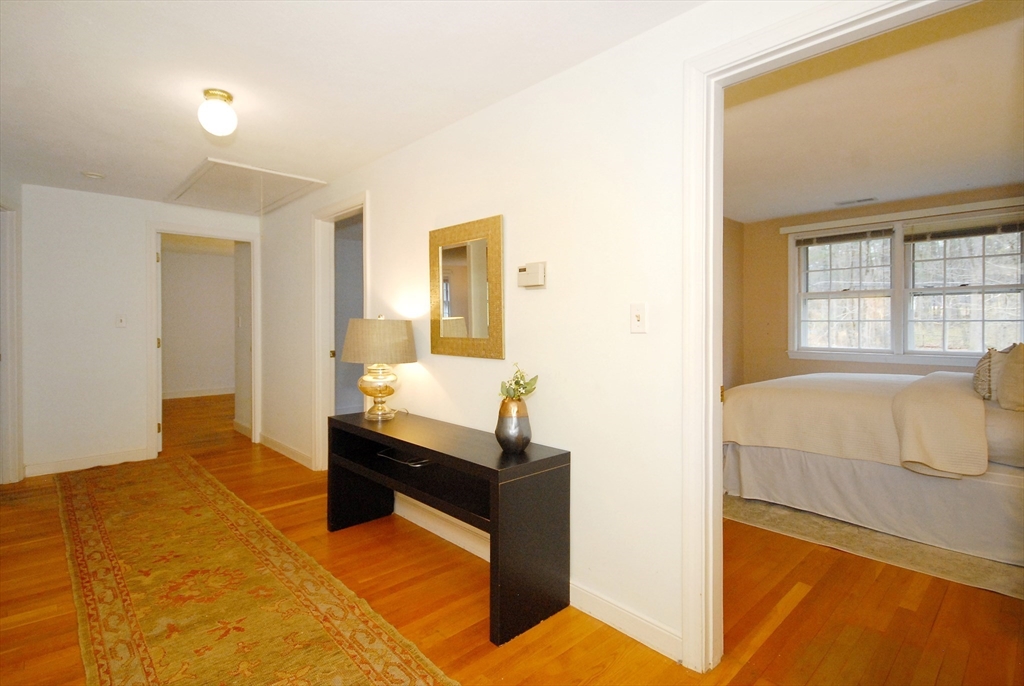 469 Hayward Mill Road Concord, MA 01742 - Photo 13 of 30 a bedroom with a bed and wooden floor