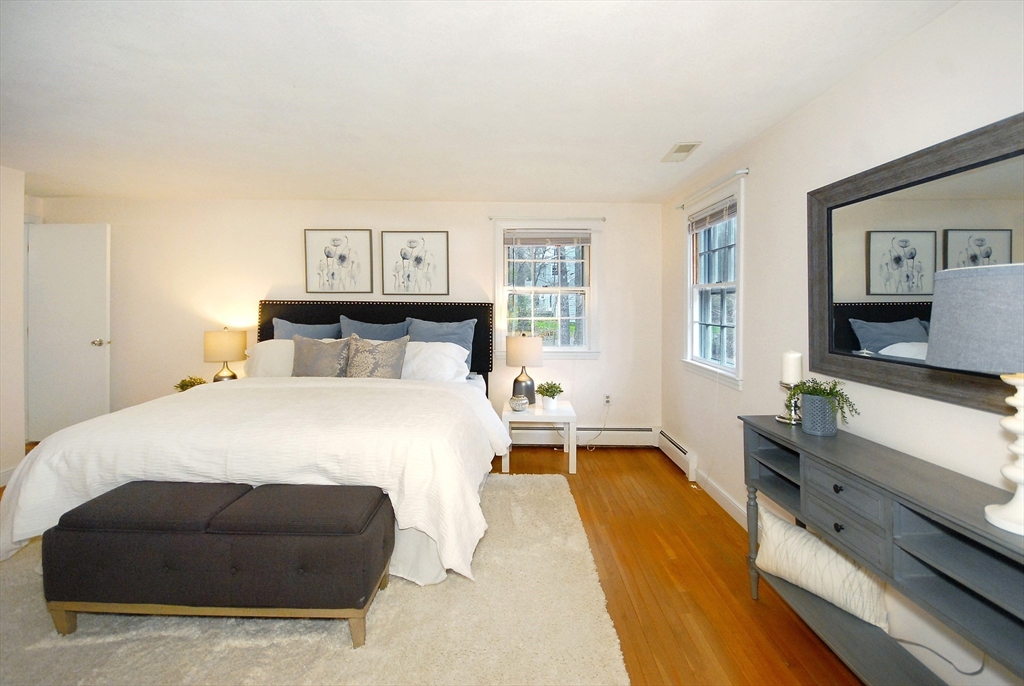 469 Hayward Mill Road Concord, MA 01742 - Photo 17 of 30 a bedroom with a bed and a flat screen tv