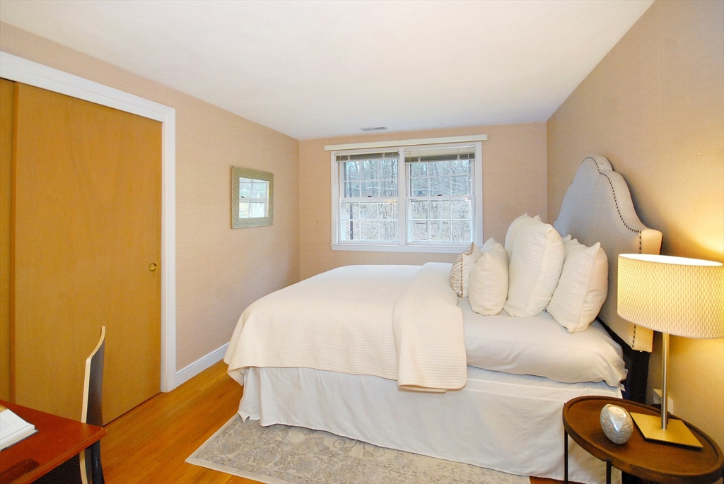 469 Hayward Mill Road Concord, MA 01742 - Photo 19 of 30 a bedroom with a bed and a lamp