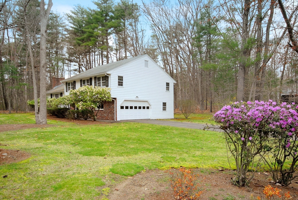 469 Hayward Mill Road Concord, MA 01742 - Photo 2 of 30 a front view of a house with a yard and garage