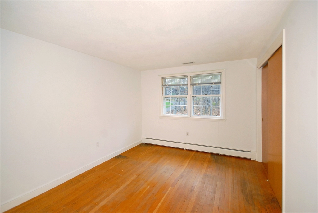 469 Hayward Mill Road Concord, MA 01742 - Photo 22 of 30 an empty room with wooden floor and windows