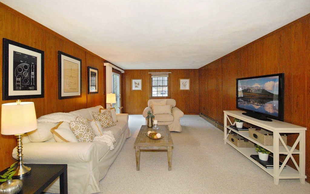 469 Hayward Mill Road Concord, MA 01742 - Photo 24 of 30 a living room with furniture and a flat screen tv