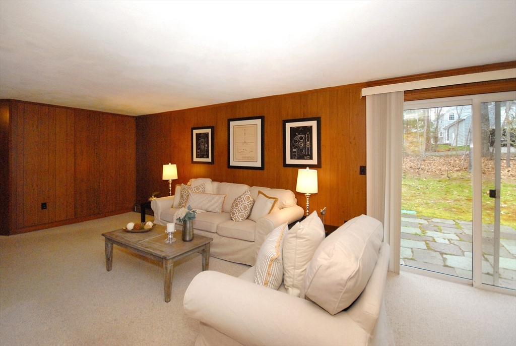 469 Hayward Mill Road Concord, MA 01742 - Photo 25 of 30 a living room with furniture and a floor to ceiling window