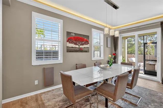 a view of a dining room with furniture large window and wooden floor
