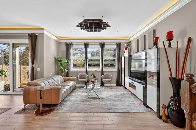a living room with furniture fireplace and a large window