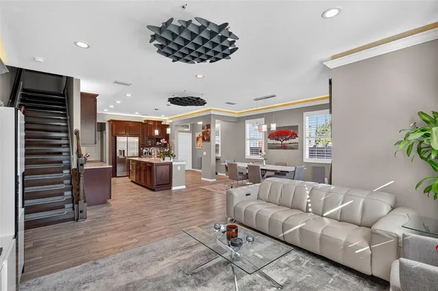 a living room with furniture and a wooden floor