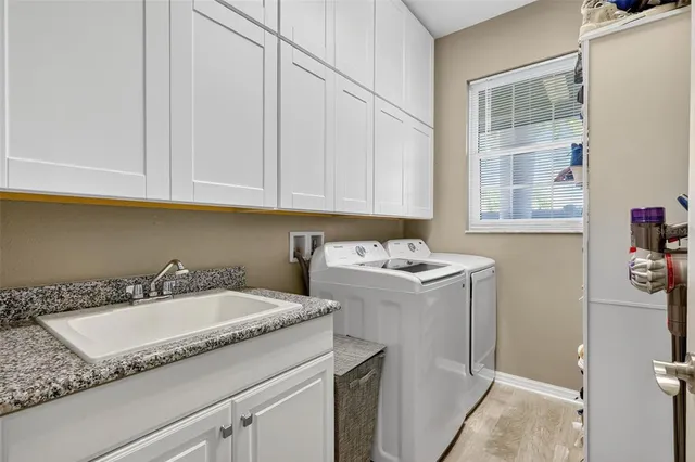 a utility room with sink dryer and washer