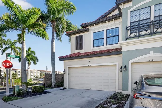 a front view of a house with plants