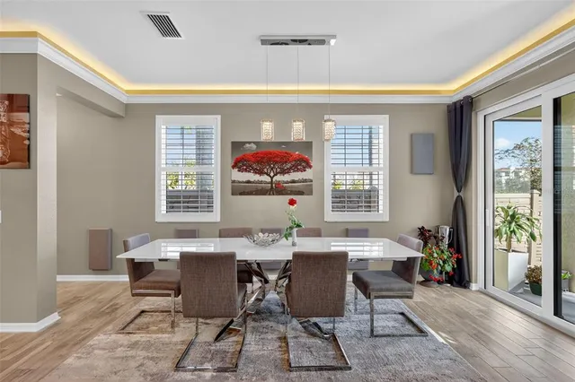 a dining room with furniture a rug and a window