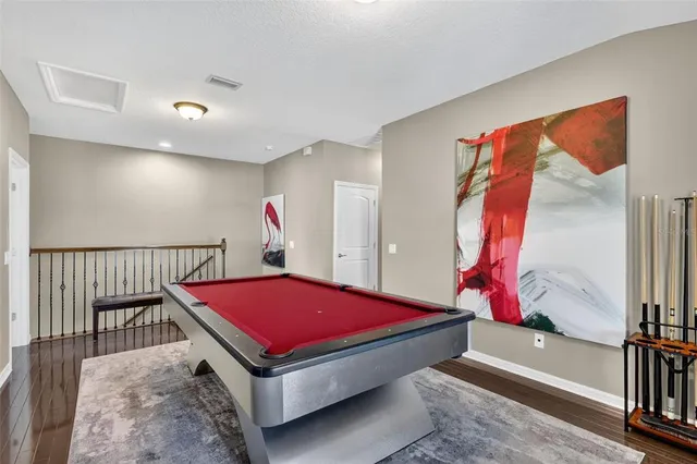 a room with pool tables and flat screen tv