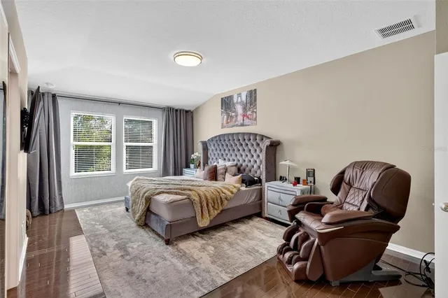 a bedroom with a bed chair and a window