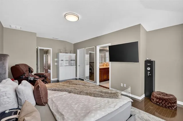 a bedroom with a bed and a flat screen tv