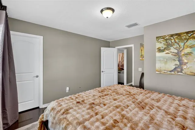 a bedroom with a large bed and a window