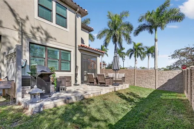a row of palm trees in front of a house