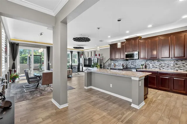 a kitchen with stainless steel appliances kitchen island granite countertop a refrigerator and stove top oven