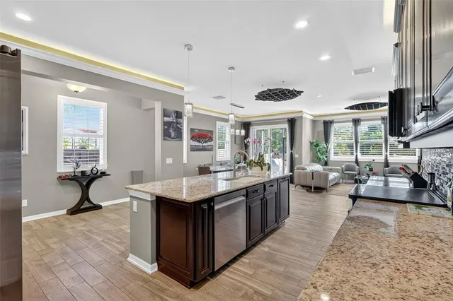a kitchen with counter space sink and living room view