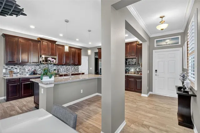 a kitchen with kitchen island granite countertop a stove and a sink