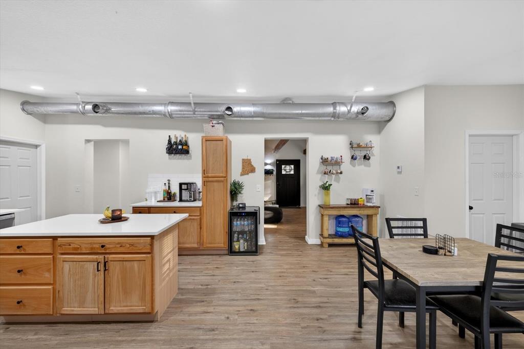 4233 Vinson Road Lakeland, FL 33810 - Photo 13 of 38 a room with stainless steel appliances kitchen island granite countertop a table chairs in it and wooden floors
