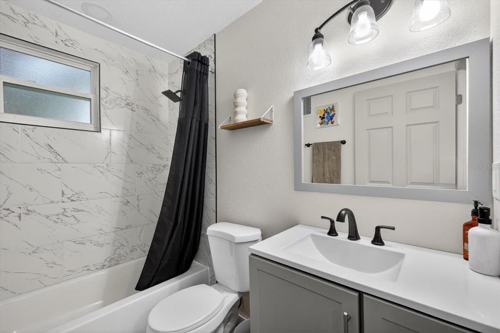 4233 Vinson Road Lakeland, FL 33810 - Photo 16 of 38 a bathroom with a sink a toilet and shower