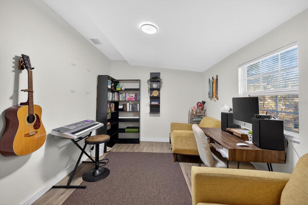 4233 Vinson Road Lakeland, FL 33810 - Photo 20 of 38 a view of a livingroom with workspace and a couch