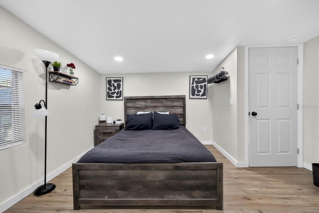 4233 Vinson Road Lakeland, FL 33810 - Photo 24 of 38 a bedroom with a bed and wooden floor