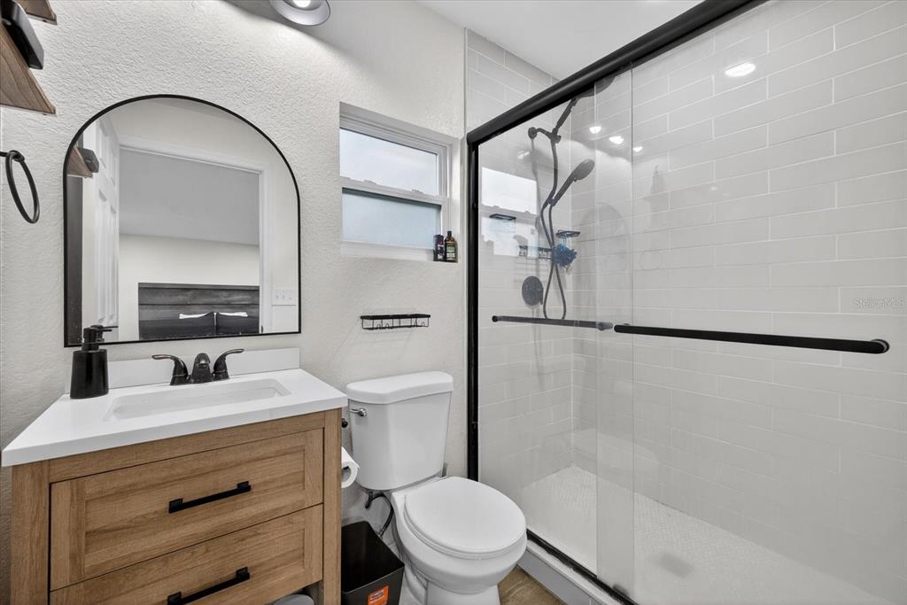 4233 Vinson Road Lakeland, FL 33810 - Photo 27 of 38 a bathroom with a granite countertop sink toilet and shower