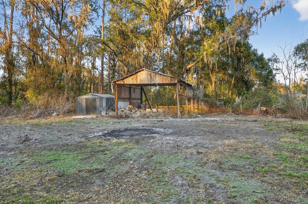 4233 Vinson Road Lakeland, FL 33810 - Photo 31 of 38 a view of a table and chairs under an umbrella