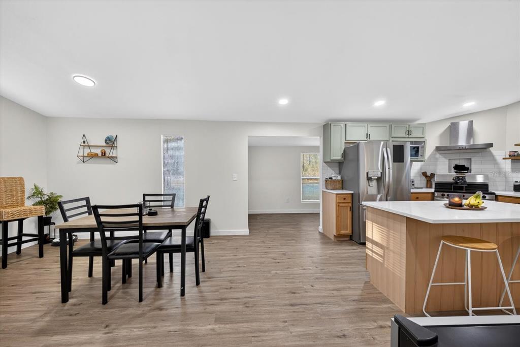 4233 Vinson Road Lakeland, FL 33810 - Photo 9 of 38 a kitchen with stainless steel appliances granite countertop a dining table chairs and granite counter tops