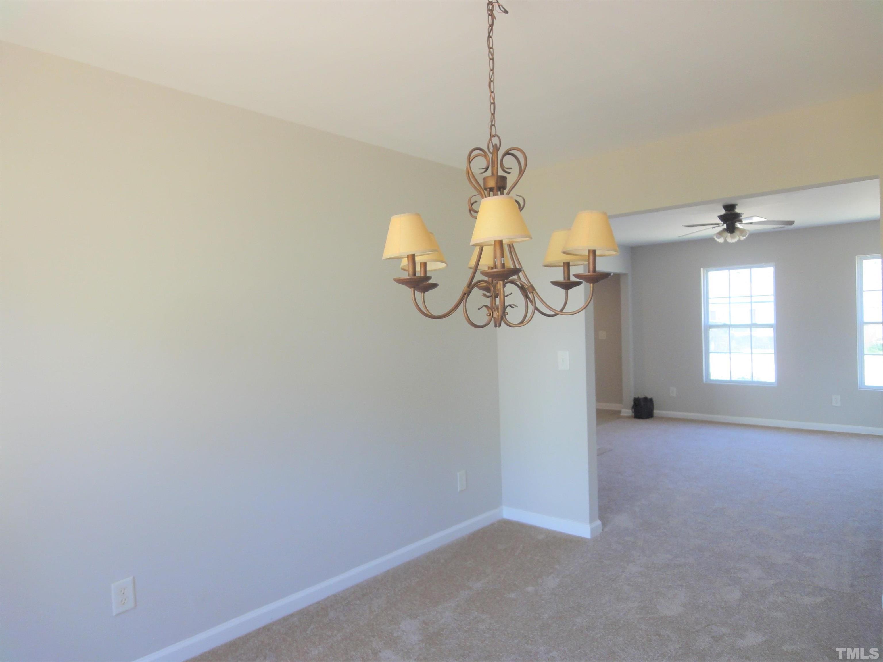 3615 Cyrus Street Raleigh, NC 27610 - Photo 12 of 36 a view of a room with a window and chandelier