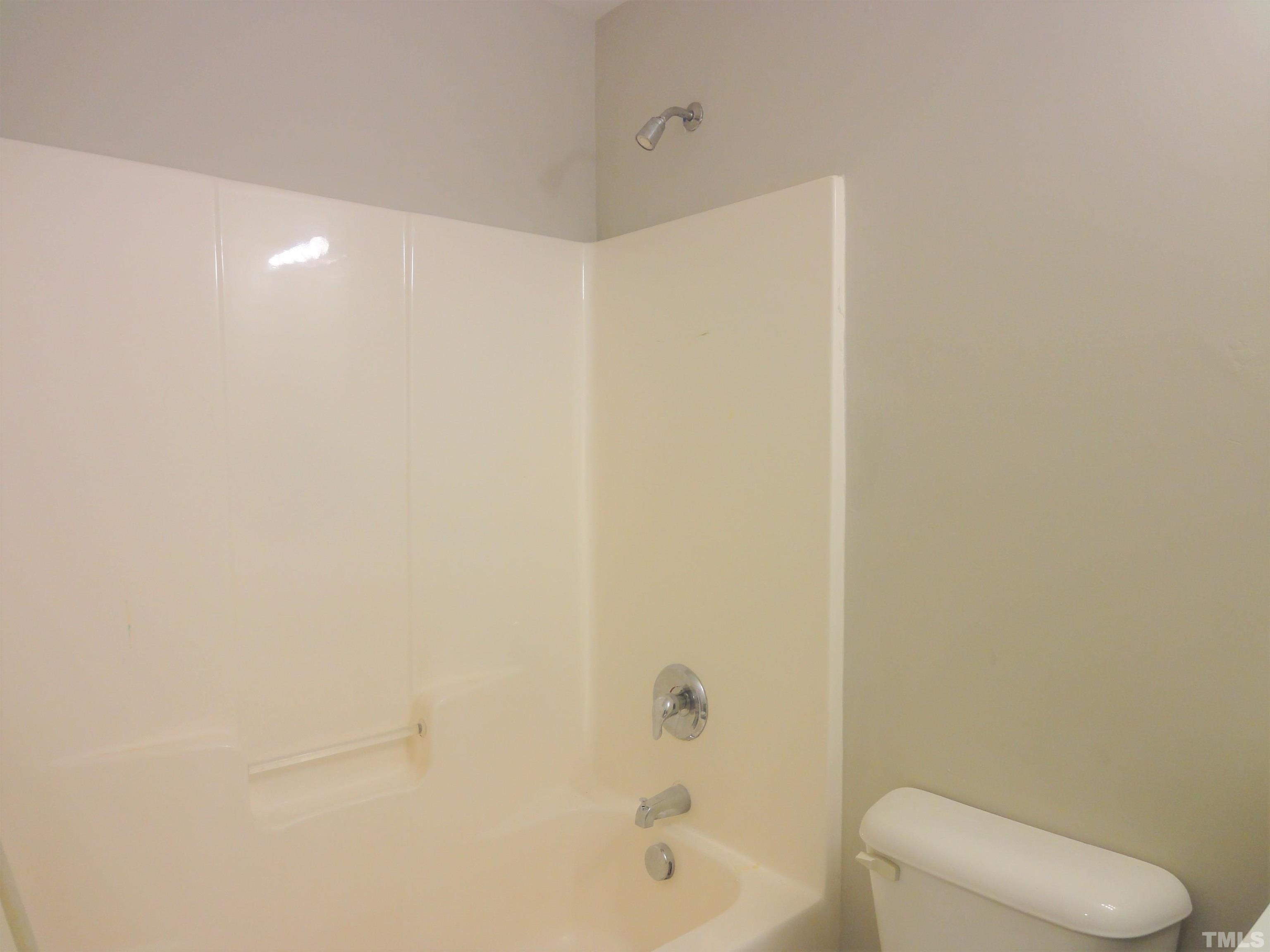3615 Cyrus Street Raleigh, NC 27610 - Photo 30 of 36 a bathroom with a bathtub and toilet