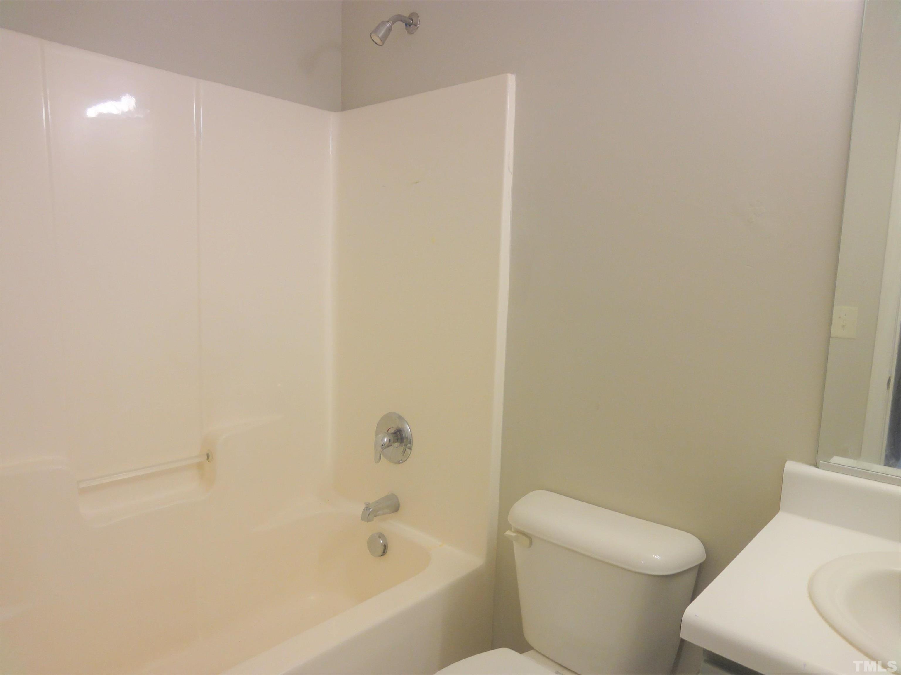 3615 Cyrus Street Raleigh, NC 27610 - Photo 32 of 36 a white toilet sitting next to a bath tub