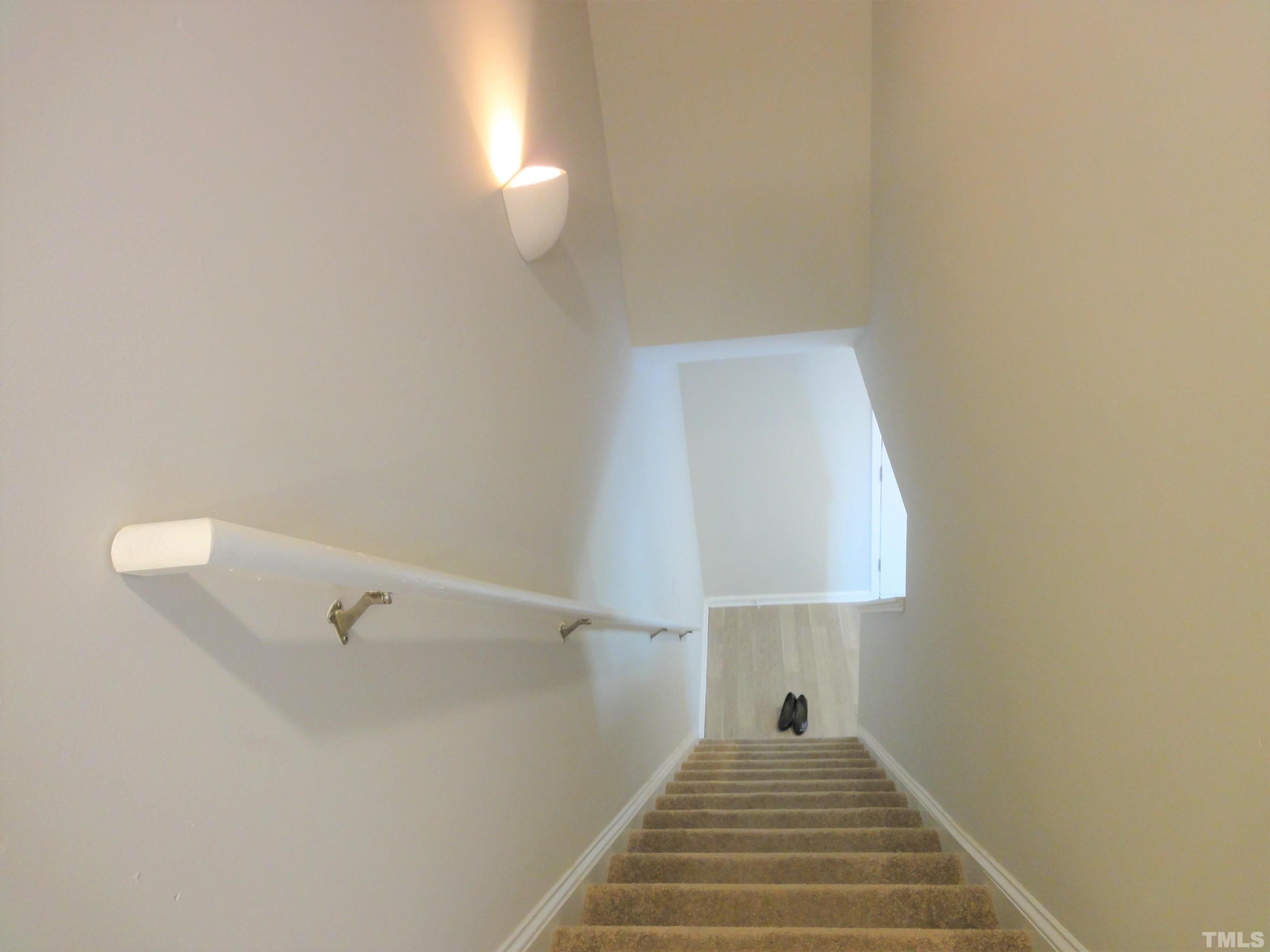 3615 Cyrus Street Raleigh, NC 27610 - Photo 33 of 36 a view of a hallway with wooden floor and a bathroom