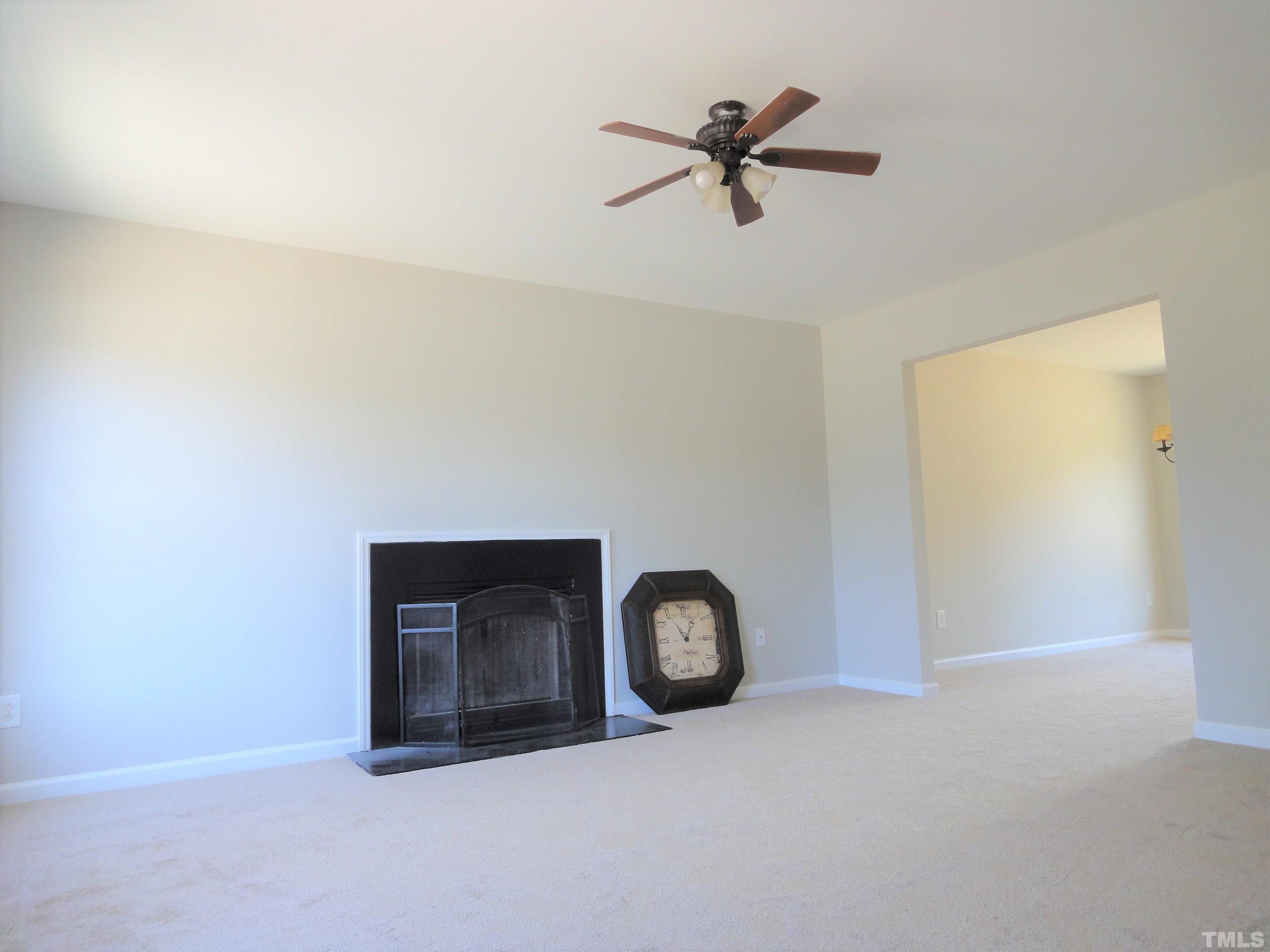 3615 Cyrus Street Raleigh, NC 27610 - Photo 5 of 36 a view of a livingroom with a ceiling fan and wooden floor
